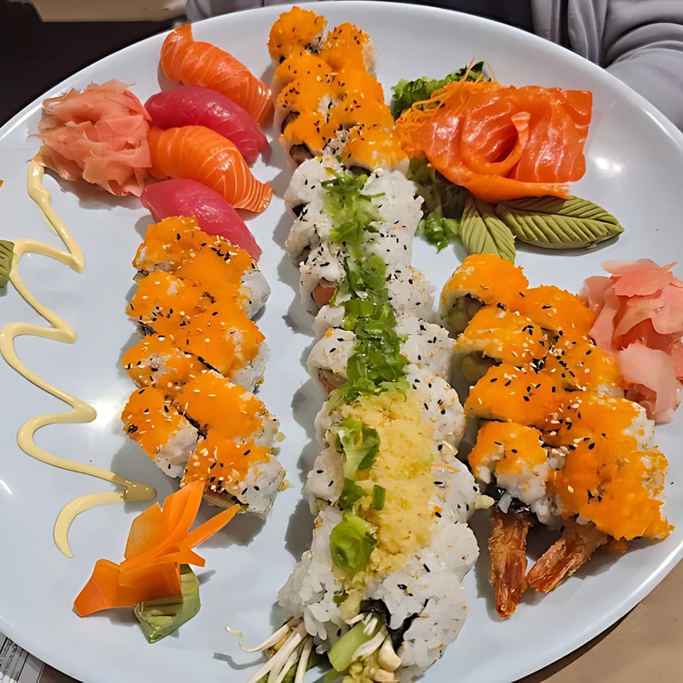 A large platter of Grille One Nine Asian Fusion sushi, sashimi, and rolls with ginger and wasabi.